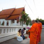 Giving alms to monks at Hua Khuang Temple, Nan
