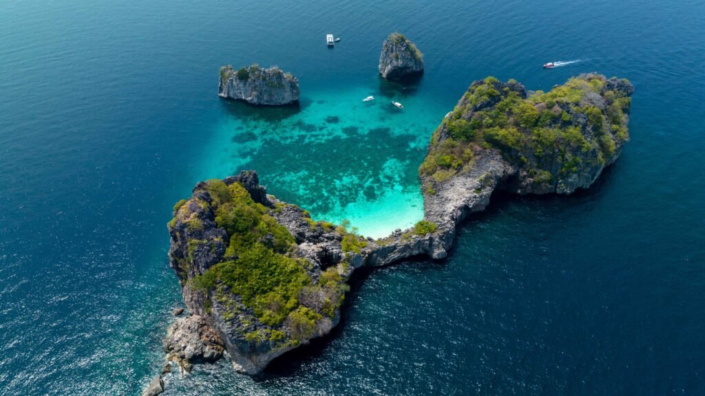 Aerial view of Ko Ha’s turquoise lagoon surrounded by limestone cliffs in Krabi, showcasing Thailand’s pristine marine beauty.